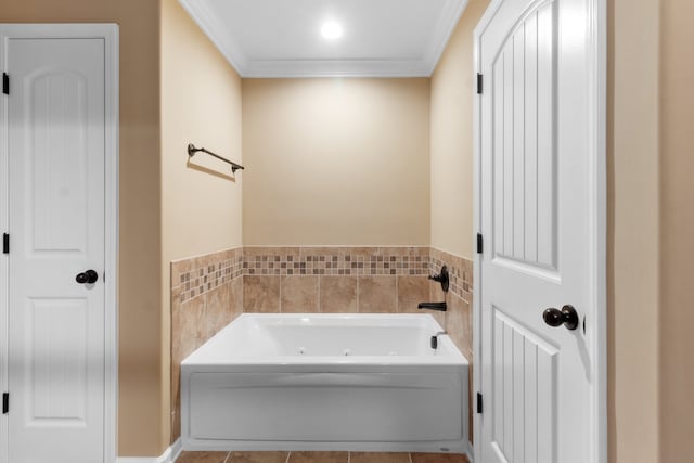 bathroom with a washtub, tile patterned floors, and crown molding