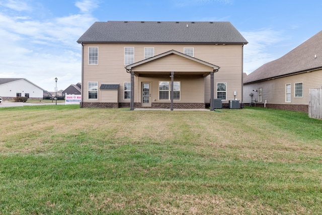 back of property featuring a yard, ceiling fan, and cooling unit