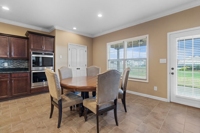 dining room with a wealth of natural light, crown molding, and light tile patterned flooring