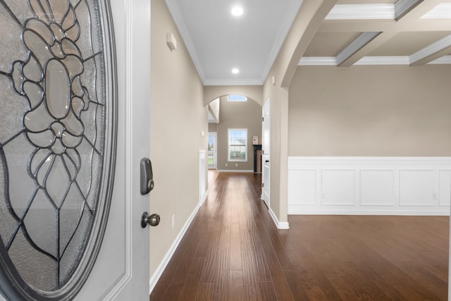 hall with beam ceiling, dark hardwood / wood-style flooring, ornamental molding, and coffered ceiling