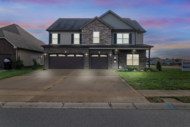 view of front facade with a garage and a lawn