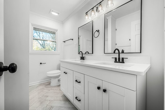 bathroom featuring parquet flooring, ornamental molding, toilet, and vanity