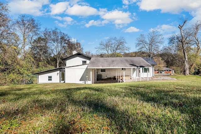 rear view of house with a patio area and a lawn