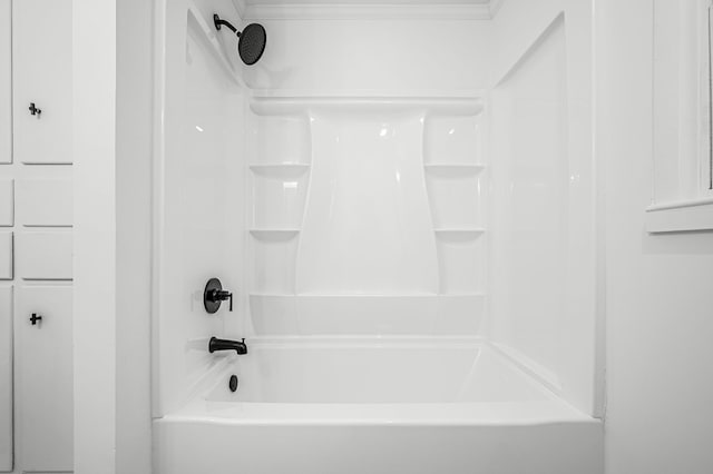 bathroom featuring crown molding and shower / bath combination