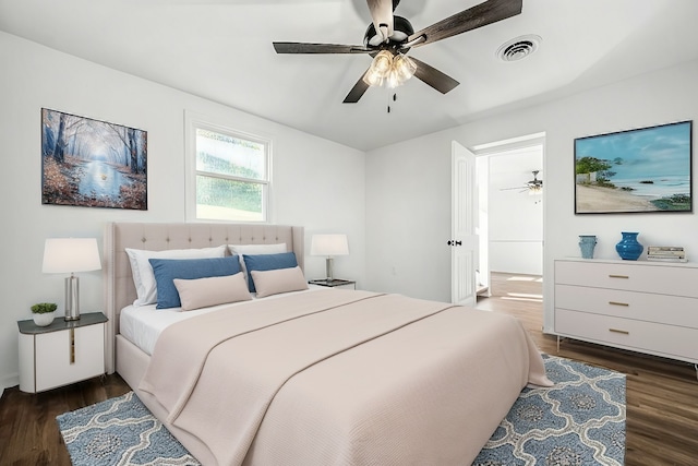 bedroom with dark hardwood / wood-style flooring and ceiling fan