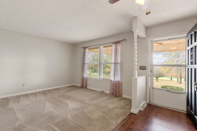 entryway featuring a textured ceiling, dark hardwood / wood-style floors, and ceiling fan