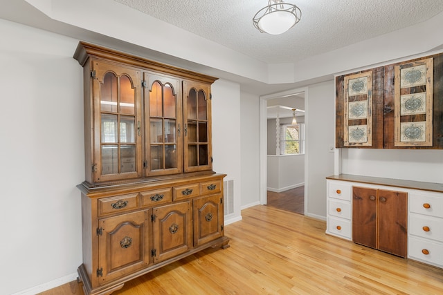 interior space with light hardwood / wood-style floors and a textured ceiling