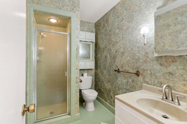 bathroom featuring tile patterned flooring, vanity, an enclosed shower, and a textured ceiling