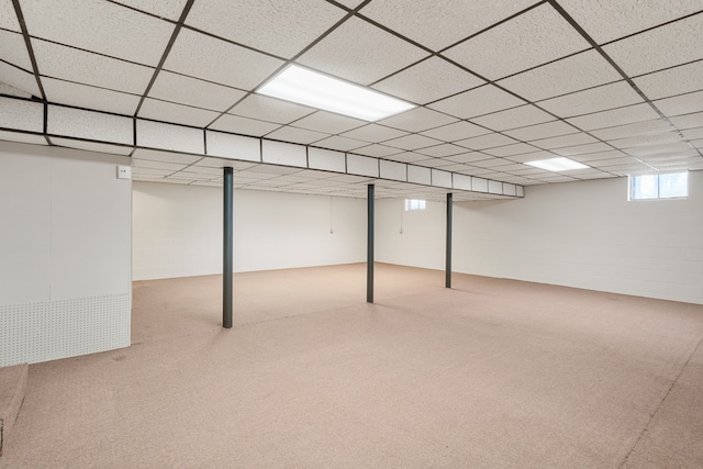 basement with a paneled ceiling