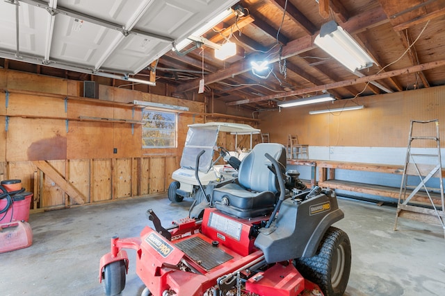 garage with wood walls and a garage door opener