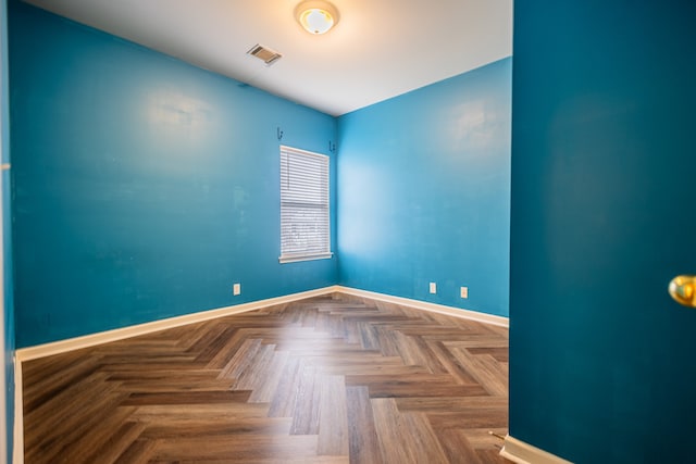 unfurnished room with parquet floors