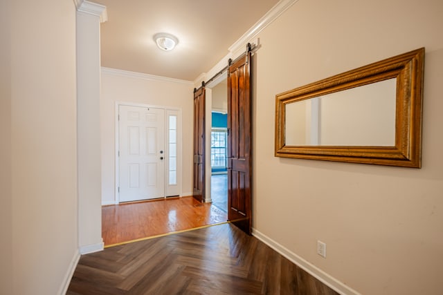 foyer entrance with dark parquet flooring, a barn door, and crown molding