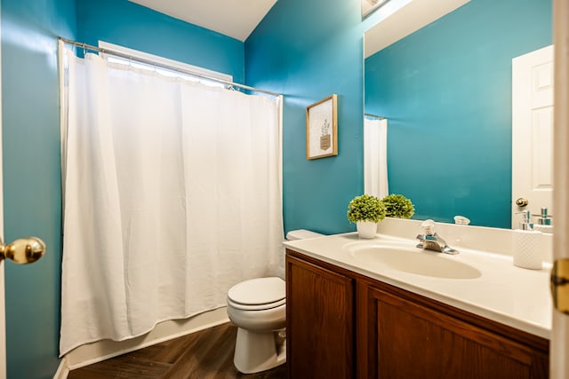 bathroom featuring hardwood / wood-style floors, vanity, toilet, and curtained shower