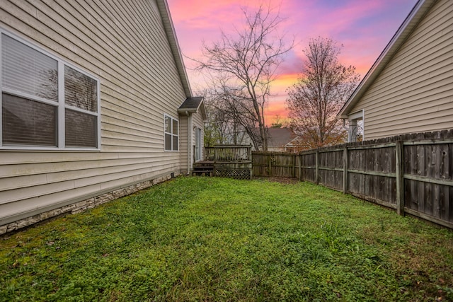 yard at dusk with a deck