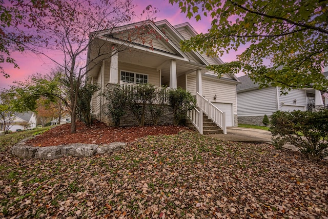 view of front of home featuring covered porch and a garage