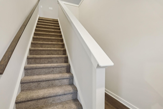 stairs featuring hardwood / wood-style flooring