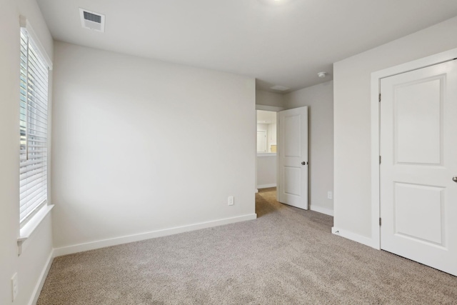 unfurnished bedroom with light carpet