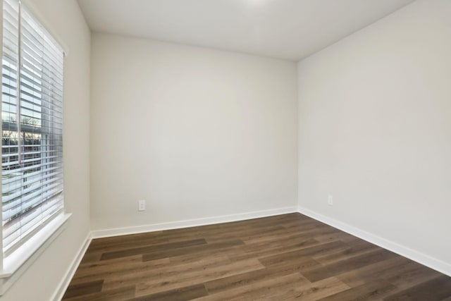 unfurnished room with dark hardwood / wood-style floors