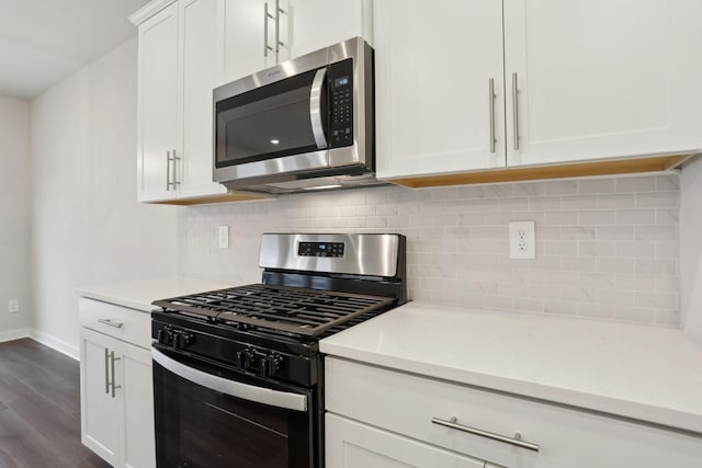 kitchen featuring white cabinetry, gas stove, backsplash, and dark hardwood / wood-style floors