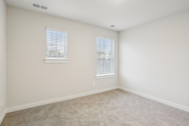 empty room featuring carpet and plenty of natural light