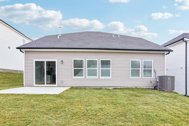 back of property with a patio, a lawn, and central air condition unit