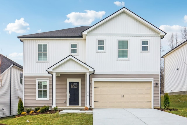 view of front of property featuring a front lawn and a garage