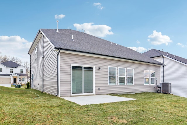 rear view of property featuring a patio, a lawn, and central air condition unit