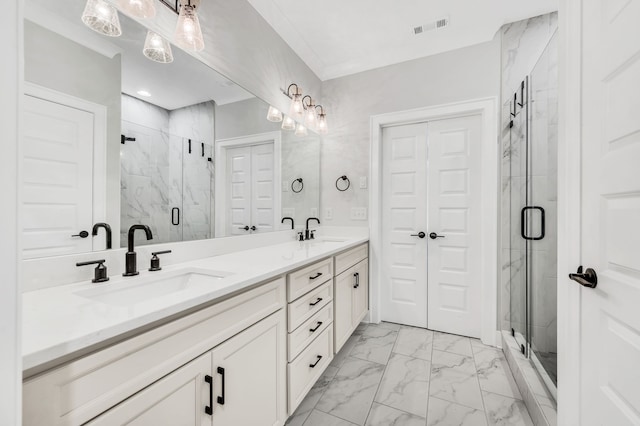 bathroom with vanity and a shower with door