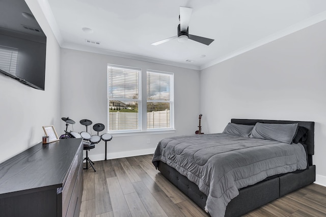 bedroom featuring ceiling fan, wood-type flooring, and ornamental molding