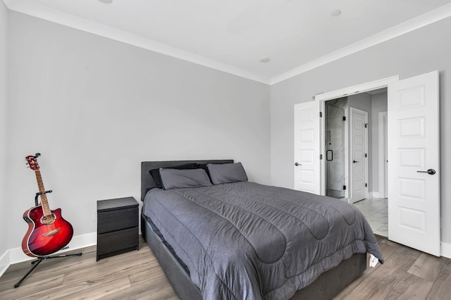 bedroom featuring light hardwood / wood-style floors and crown molding