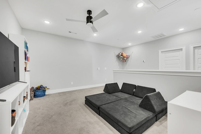 carpeted living room with ceiling fan