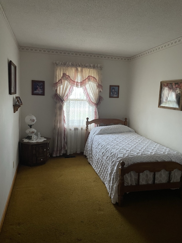 bedroom featuring a textured ceiling and carpet floors