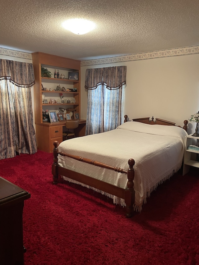 carpeted bedroom featuring a textured ceiling