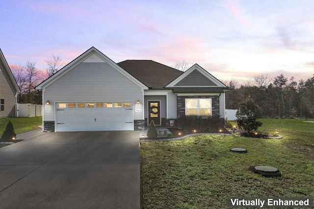 view of front of property featuring a yard and a garage