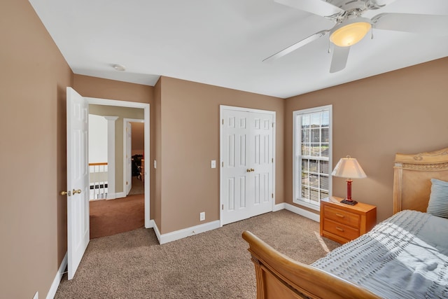 carpeted bedroom featuring ceiling fan and a closet