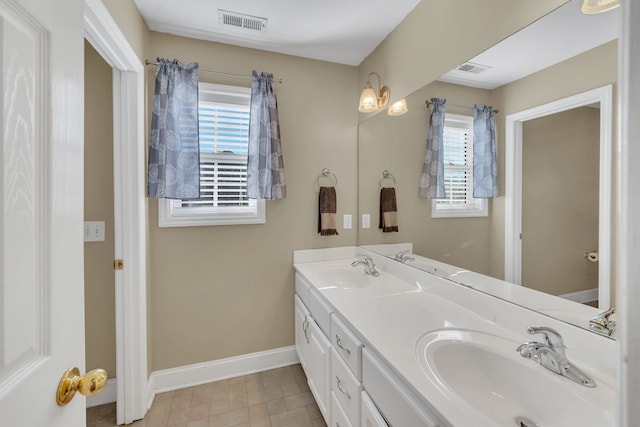 bathroom with tile patterned flooring and vanity