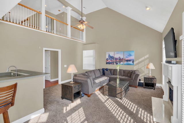 carpeted living room with high vaulted ceiling and ceiling fan