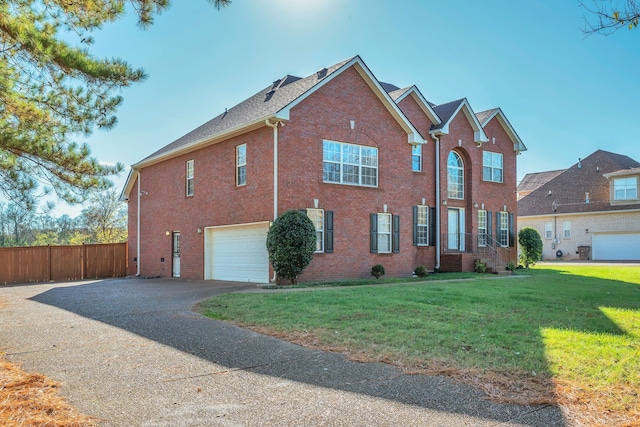 view of front facade featuring a front yard and a garage