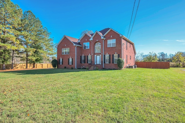 view of front of home featuring central AC unit and a front yard