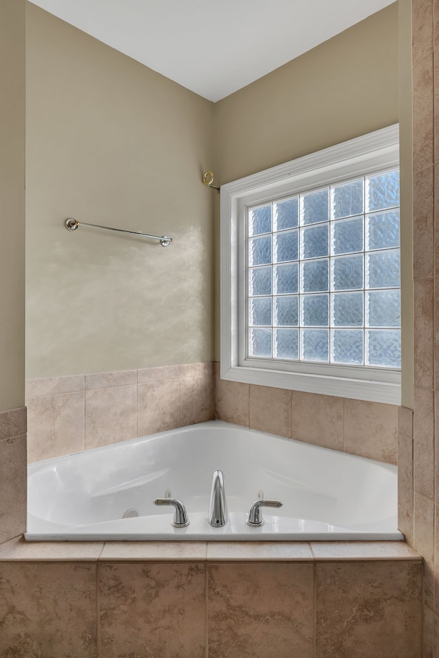 bathroom featuring a relaxing tiled tub