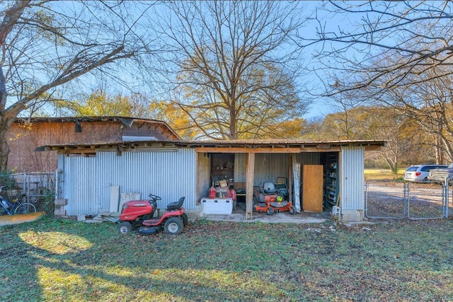 view of pole building with a lawn and fence