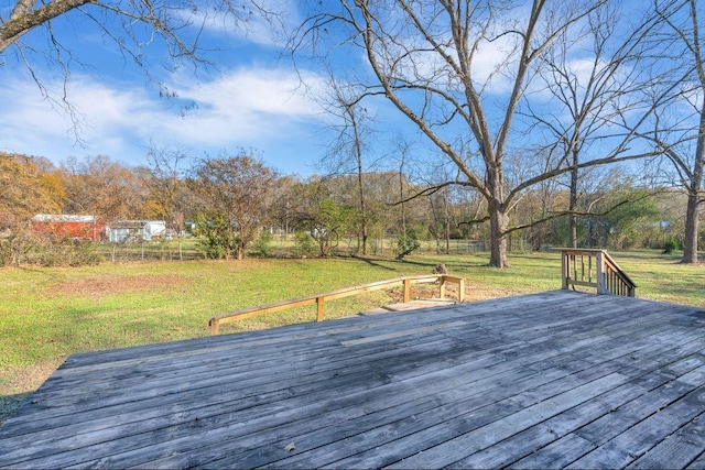 wooden terrace featuring a yard