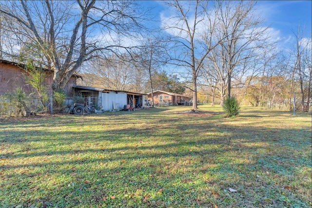 view of yard featuring an outdoor structure and an outbuilding