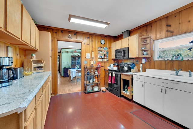 kitchen featuring dark wood-style floors, wooden walls, stainless steel electric range, black microwave, and light countertops