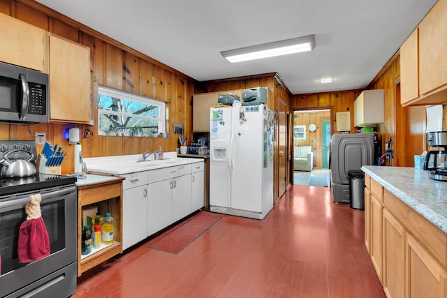 kitchen with wooden walls, wood finished floors, light countertops, stainless steel range with electric stovetop, and white fridge with ice dispenser