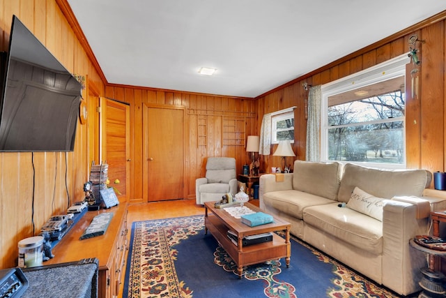 living room with crown molding, wood finished floors, and wood walls