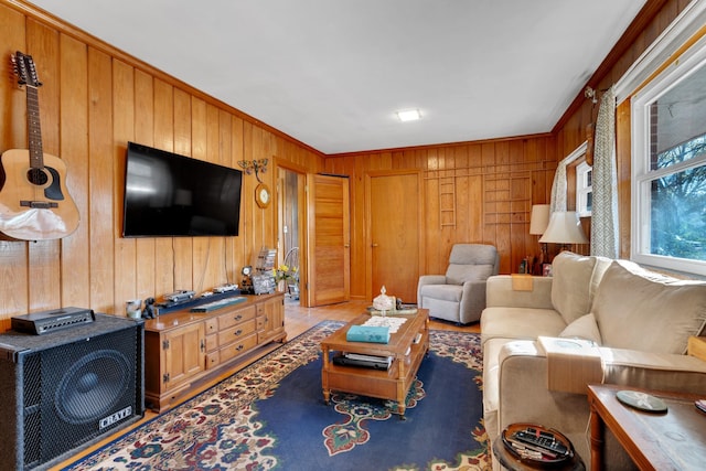 living room with wooden walls and crown molding