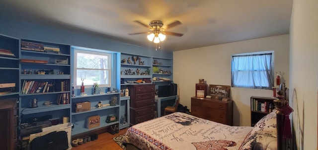 bedroom featuring wood finished floors and ceiling fan