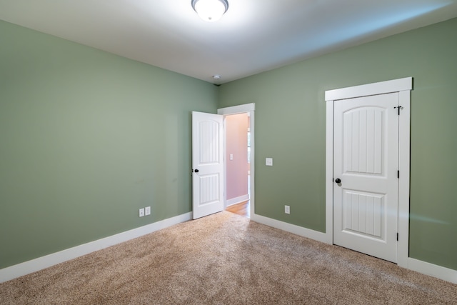 unfurnished bedroom with carpet and a closet