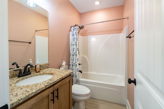 full bathroom featuring hardwood / wood-style floors, vanity, toilet, and shower / bath combo